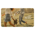 Gift card with a background image of two girls walking through a field holding their Dansko shoes, with the overlay text reading "Online Gift Card". The Dansko logo is overlaid on the right hand side.