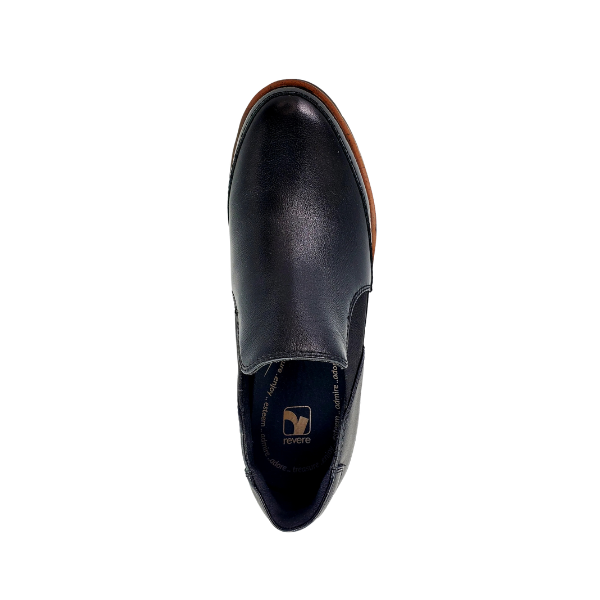 The REVERE Womens Mykonos Wedge Loafer Black is a black leather slip-on with a brown sole and dark insole featuring the revere logo—perfect loafers for women who want comfort, style, and ideal arch support.