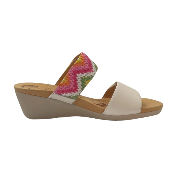The REVERE Womens Sorrento White wedge sandal features a white two-strap design—one plain, one with a multicolored zigzag pattern—a tan footbed, light brown sole, and orthotic support for stylish foot pain relief.