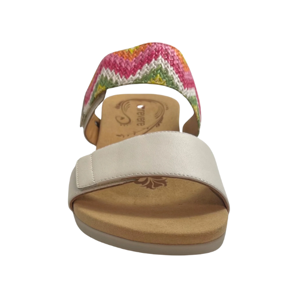 The REVERE Revere Womens Sorrento White sandal features a beige leather front strap and a colorful woven zigzag ankle strap in pink, green, yellow, and white, combining stylish design with foot pain relief against a white background.