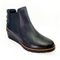 The REVERE Reverse Womens Galway Wedge Bootie Wide in black features a premium leather upper, low wedge heel, brown trim around the sole, and elastic side panels, shown on a white background.