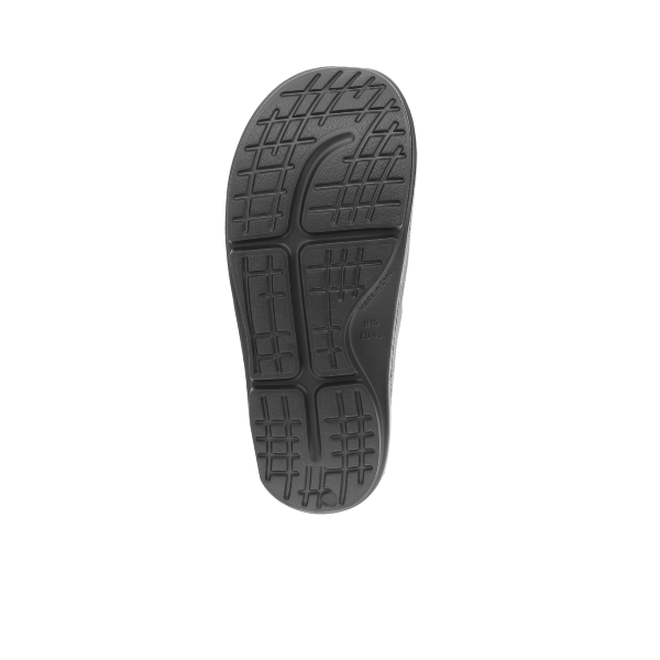 The SOVELLA Sovella Mens Buckle Slide Black features a black sole with a textured tread, including rectangular and curved grooves for grip and arch support, shown from the bottom against a white background.