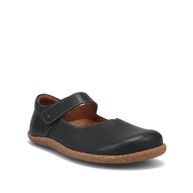 The TAOS Taos Women's Ultimate Leather Mary Jane Black is a comfortable women's flat shoe featuring a black leather upper, brown cork sole, arch support, and top strap. Photographed against a plain white background.