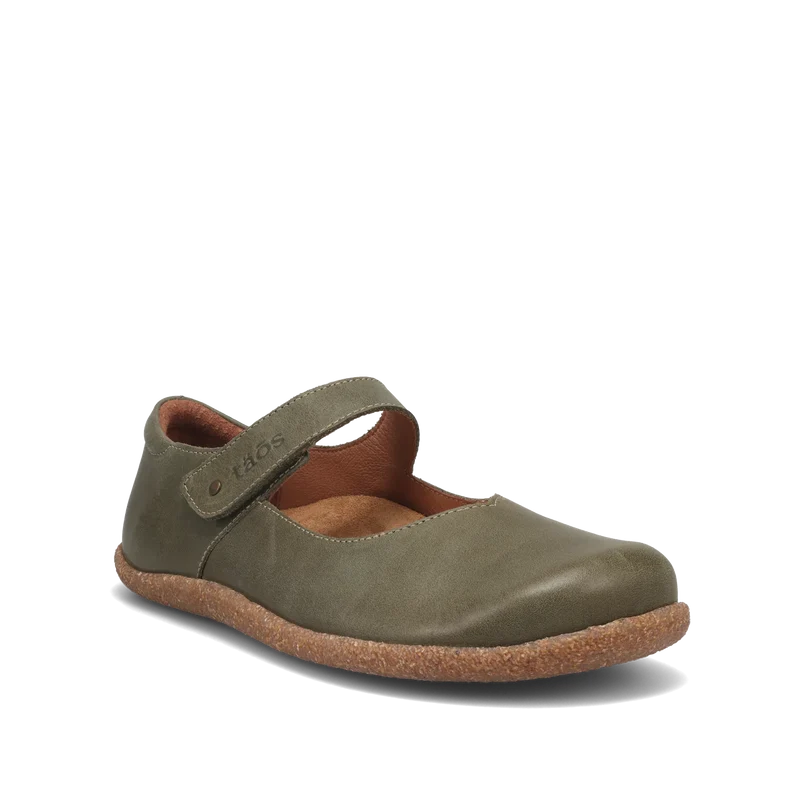 The TAOS Taos Women's Ultimate Leather Mary Jane Forest is a single olive green leather shoe with a hook-and-loop strap, brown suede lining, and textured rubber sole with arch support, shown on a white background.