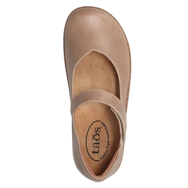 The Taos Women's Ultimate Leather Mary Jane Mushroom features a rounded toe and adjustable strap, with the TAOS comfort insole, logo, arch support, and is orthotic friendly. Shown from above on a white background.