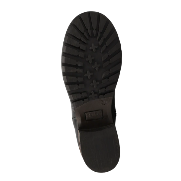 The image shows the bottom view of a TAOS Women's Uptown Black ankle boot sole, featuring a textured, rugged tread pattern with cross-shaped treads and grooves for traction, ideal for added arch support.