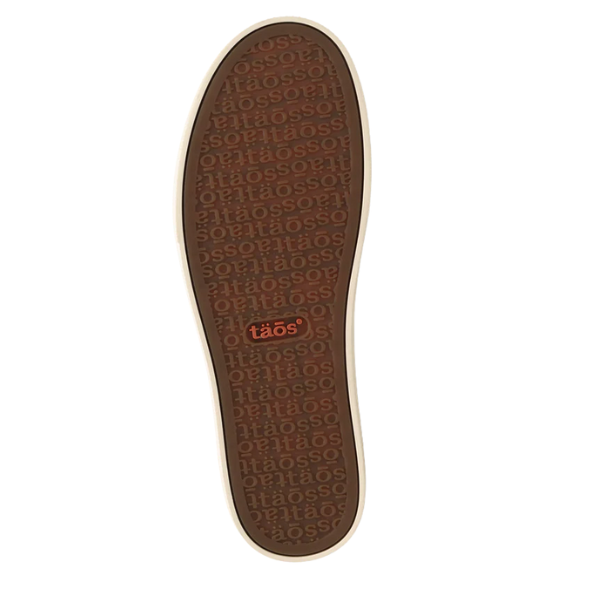 Light beige outer edge with a brown sole, repeatedly embossed "taös" text, and a larger orange "taös" logo at the heel—features of the TAOS Women's Z Soul Daisy Plum sneaker, known for comfort and plantar fasciitis support.