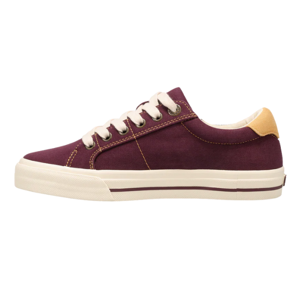 The Taos Women's Z Soul Daisy Plum sneaker by TAOS features a maroon upper, white laces and sole, tan heel accent, and offers plantar fasciitis support—shown in side profile on a white background.
