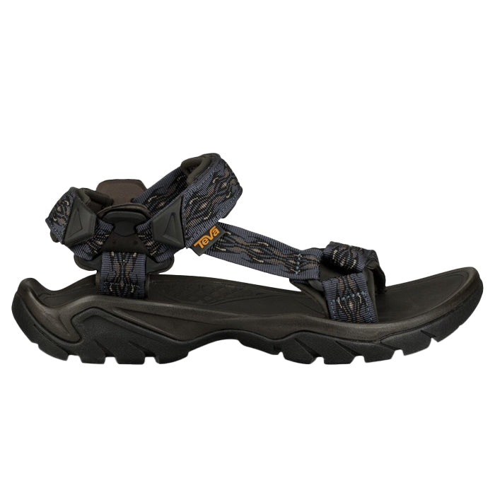 A blue and dark gray Teva Mens Terra FI 5 Universal Madang Blue hiking sandal with adjustable straps, rugged sole, and small orange logo on the side strap shown in profile; an all-terrain sandal by Teva.