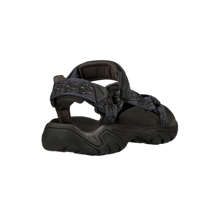 The Teva Mens Terra FI 5 Universal Madang Blue is a dark blue, open-toe sandal with adjustable straps and a thick, textured sole, shown from the back against a white background.