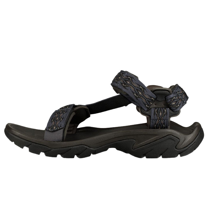 The Teva Mens Terra FI 5 Universal Madang Blue sandal features adjustable straps, a thick rugged sole, and a subtle pattern, making it a versatile all-terrain choice for hiking.