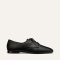 The Billie Derby - Black Nappa by Margaux, a classic black leather lace-up dress shoe, shown in a side view against a plain white background.