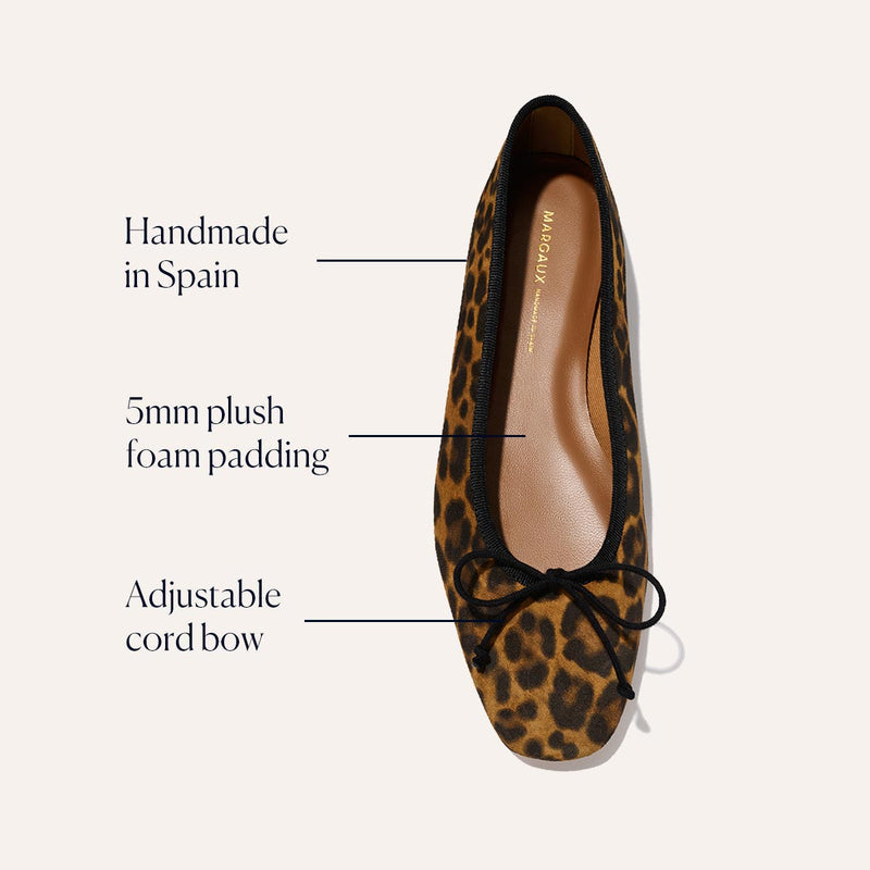 The Fonteyn - Leopard Suede by Margaux is a handcrafted ballet flat made in Spain, featuring leopard print suede, a comfort-focused 5mm plush foam insole, and an adjustable cord bow on the front.