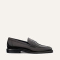 The Marlowe Loafer - Black Calf by margaux-development is a sleek black leather loafer with visible stitching, low heel, and minimal design, shown in side profile on a plain light background.