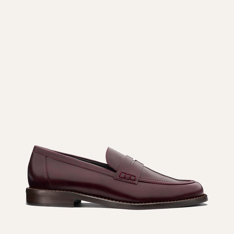 The Marlowe Loafer - Burgundy Calf by margaux-development is shown in a side profile, displaying burgundy leather, a low heel, and stitching detail against a plain light background.
