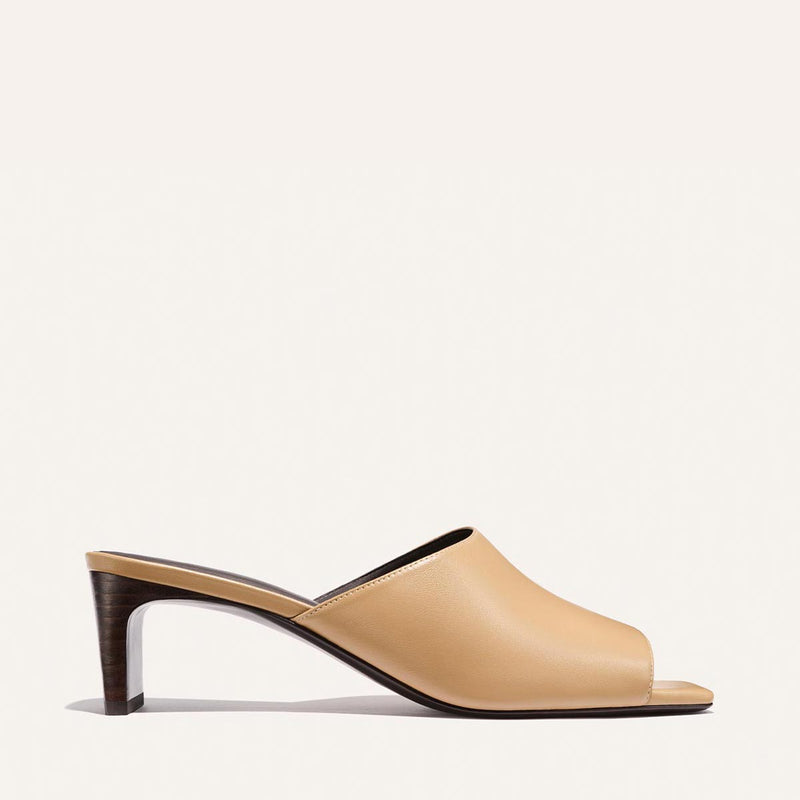 Beige high-heeled shoe on a white background