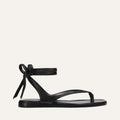 Black sandal with a bow on a white background