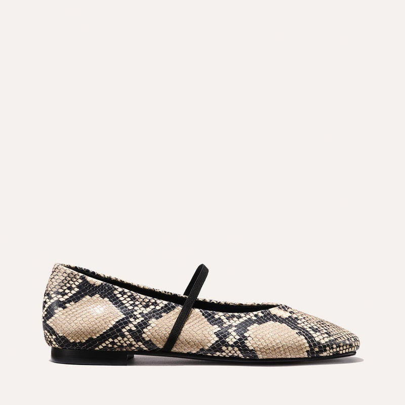 The Phoebe - Natural Python Embossed by margaux-development is a deconstructed flat in beige and black python embossing, featuring a black sole and a single thin black strap across the top.