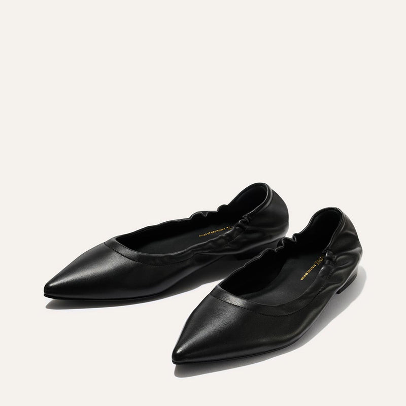 The Roma - Black Nappa by Margaux: black pointed-toe ballet flats with elasticated sides, crafted from smooth leather, shown against a plain white background.