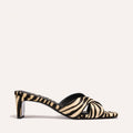 The Selene 50 - Tan Zebra Haircalf by Margaux is a heeled sandal with an open toe and crisscross straps in a black and beige zebra print, shown against a plain light background.