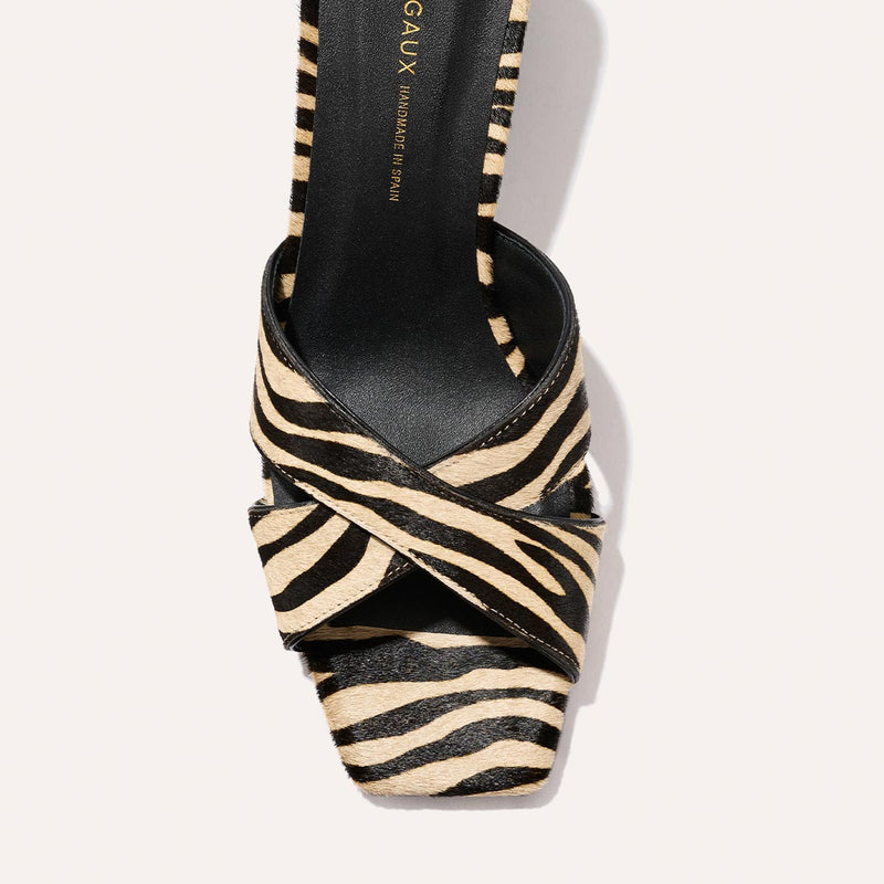 Top view of Margaux’s The Selene 50 sandal in Tan Zebra Haircalf, showcasing crisscross black and beige zebra print straps and a square toe design.