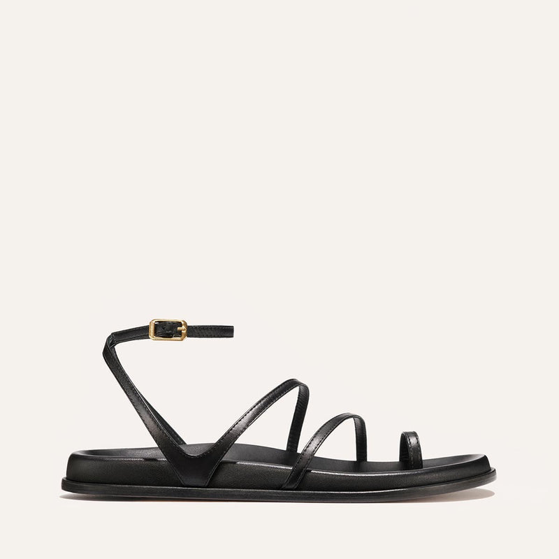Black sandal with thin straps on a white background