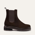 The West Chelsea Boot - Cocoa Suede by margaux-development is a dark brown, water-resistant suede Chelsea boot with a thick lug sole, elastic side panels, back pull tab, and a rounded toe, shown in profile against a light background.