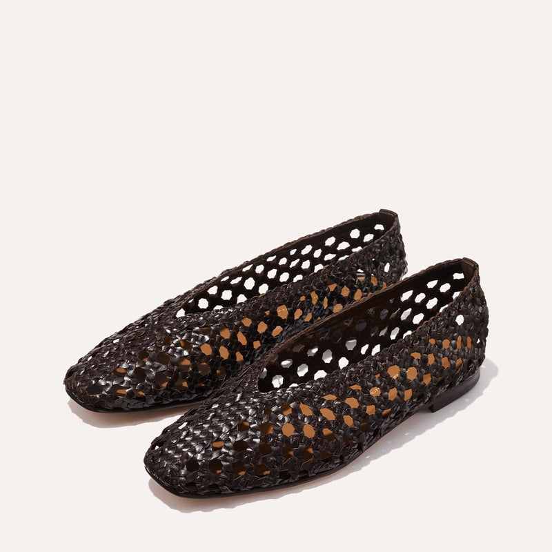 The Woven Paz SS25 - Espresso Leather flats by Margaux, featuring a handwoven cutout lattice pattern, are displayed on a plain light background.