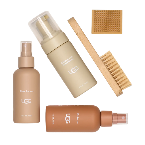 The UGG Care Kit by UGG includes Shoe Renew spray, Cleanser & Conditioner foam, shoe protector spray, a wooden brush with bristles, and a textured cloth—perfect for keeping your sheepskin boots looking their best.