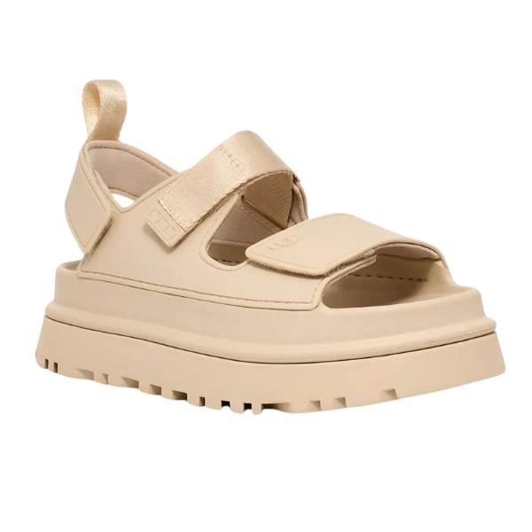 The UGG Womens Goldenglow Sandal Beige features a thick, rugged platform sole, open toe, adjustable velcro straps at the front and ankle, and a back loop for easy wear.
