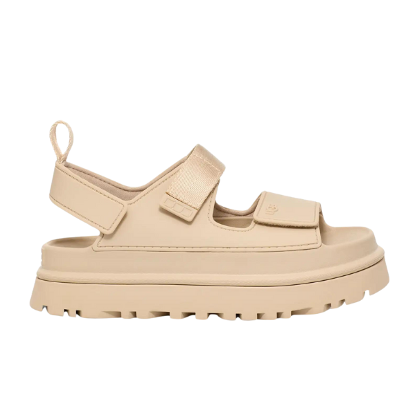 The UGG Womens Goldenglow Sandal Beige features a chunky, textured sole, open toe and heel, velcro straps across the top, and a back pull tab—perfect platform sandals for any look.