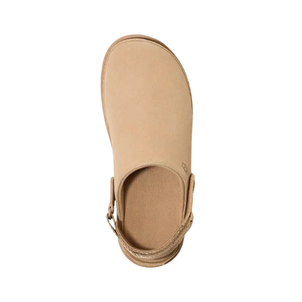 Top view of the UGG Womens Goldenstar Clog Sand by UGG, shown in beige with a closed toe and adjustable back strap for comfort, displayed on a white background.
