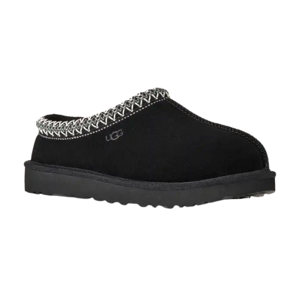 The UGG Women's Tasman II Black slipper features black suede, a thick sole, and patterned trim—shown in side view on a white background, it's ideal for those who love classic women's sheepskin slippers.